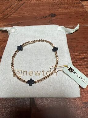 Enewton extends signature navy cross/gold 3 mm beaded bracelet with pouch.